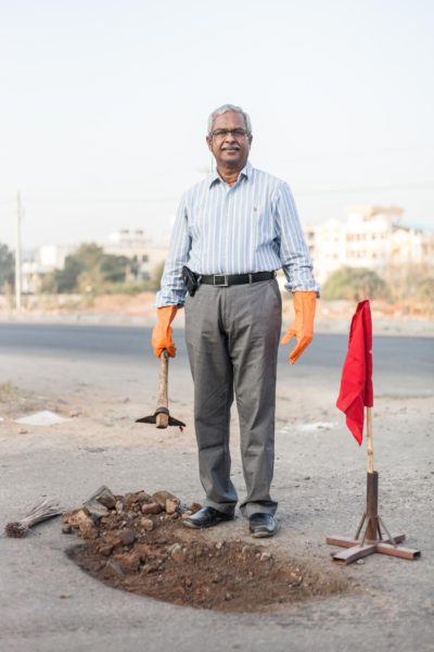 Environmental portrait of Gangadhara Tilak Katnam, who fills up potholes in Hyderabad, by photographer Harsha Vadlamani.