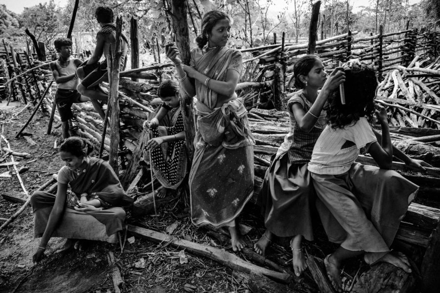 Indigenous Murias spend an afternoon under a banyan tree in Balimera.