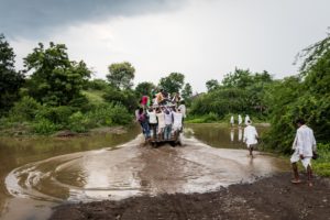 A jeep carrying Adivasis uphill towards Chandankhedi in Dhar, Madhya Pradesh, fords the rushing backwaters of the dam. September 11, 2017.