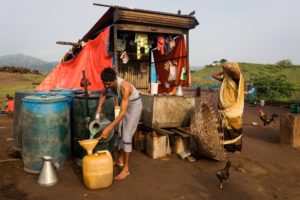 Kirta Bhaila, 38, fills up a jerry can with fuel for one of his two motorised boats. Bhaila and his wife Jili, 36, are now the only residents of a neighbourhood that has turned into an island, in Kakrana, Alirajpur, Madhya Pradesh. September 12, 2017.