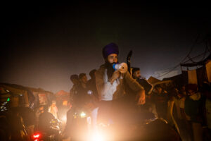 A group of protestors go around shouting slogans from atop their tractor at Singhu. December 08, 2020.