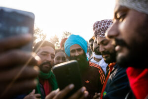 Protesting farmers take selfies with Punjabi singer Kanwar Garewal at Tikri. The protests have received a great deal of support from singers and artists from the region, and the anger against the Farm Bills is being channelled through music. Ailaan, one of Grewals’s songs that went on to become protest anthems, was later taken down by Youtube, prompting complaints of yielding to pressure from the government. December 14, 2020.