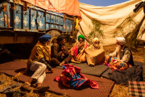 Farmers under a makeshift tent propped up between tractor trailers at the Tikri protest site. While the farmers protesting at Singhu come from the wealthier Majha and Doaba regions of Punjab, the ones at Tikri come from the infertile Malwa, which also records most of Punjab’s farmer suicides. The farmers here have smaller landholdings, or are even landless. December 14, 2020.