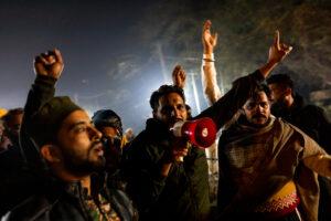 A group of young farmers raise slogans in the night at Singhu. December 08, 2020.