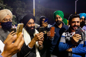 Farmers record and livestream a song recital by Jasbir Singh Dhillon, 65, who also wrote the lines and set tune to them, about the farming crisis in Punjab. Singhu protest site, December 09, 2020.q
