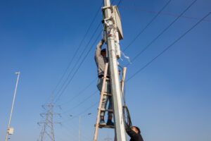Technicians hired by the police install surveillance cameras at the Ghazipur protest site. December 13, 2020.