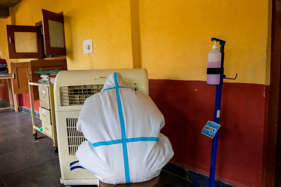 A nurse relaxes in front of an air cooler in the COVID-19 ward at Jan Swasthya Sahyog hospital in Ganiyari in Bilaspur, Chhattisgarh. May 17, 2021.