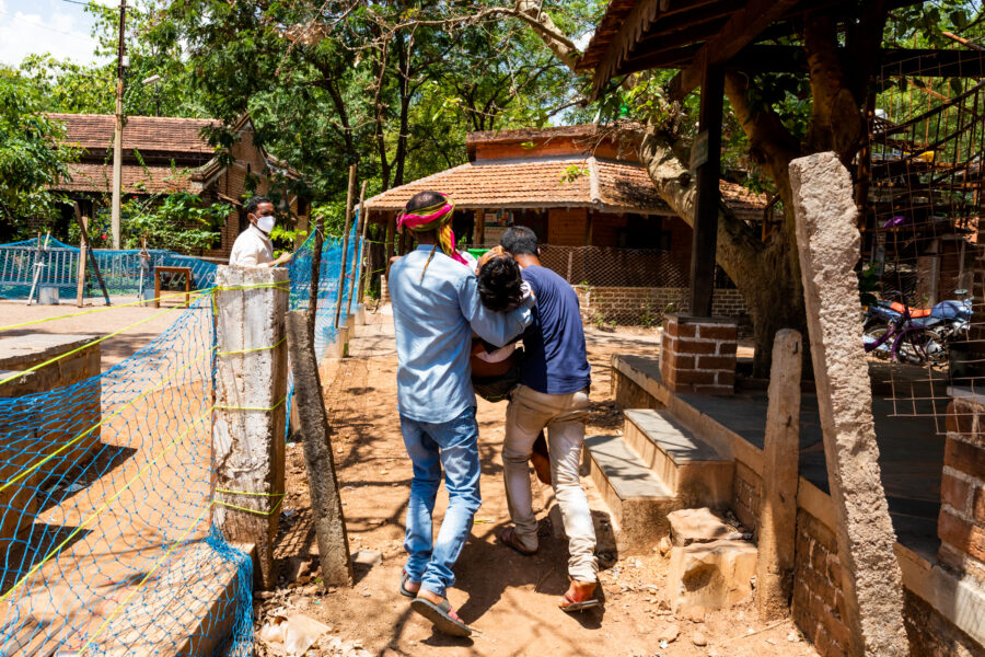 A person running a high temperature and suspected of having COVID-19 is brought to the Jan Swasthya Sahyog hospital at Ganiyari in Bilaspur, Chhattisgarh. May 18, 2021.