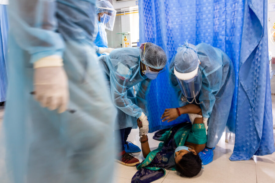 Medical staff tend to Suhanu Das, 46, who fainted as she watched a sample being taken from her husband Anand Das's nose to test for Black Fungus (Mucormycosis), in the ICU at the Government Medical College Hospital in Ambikapur in Surguja, Chhattisgarh.  May 22, 2021.