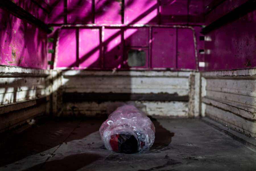 The body of Sunita Bilavekar, 18, cocooned in plastic wrap lies in the bed of a pickup truck at the MAHAN Trust hospital to be transported home. Married for only six months, she died of COVID-19 complications minutes after being brought to the intensive care unit. She was later cremated on the family's farmland. Midnight hours of June 02, 2021.