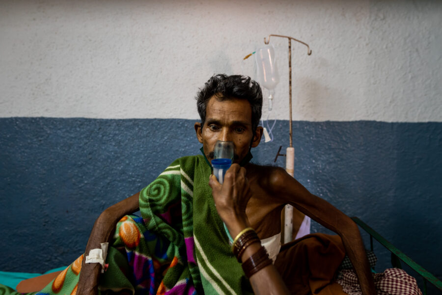 Binda Bai, 50, holds a nebuliser for her husband Sankuram Uike, 50, who was admitted to Shaheed Hospital in Dalli Rajhara in Balod, Chhattisgarh, after complications arising from the consumption of alcohol immediately after vaccination as well as a relapse of tuberculosis. June 09, 2021.