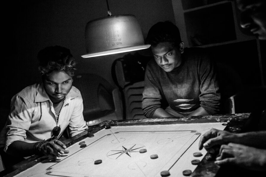 Anil Kumar Kuntapaka (21), Arun Kumar Yalanati (26) and Vinod Kumar Giriboina (28) engage themselves in a game of carrom at the office of the newly formed Telangana State Junior Artistes Association in Indira Nagar, Hyderabad. March 2015.