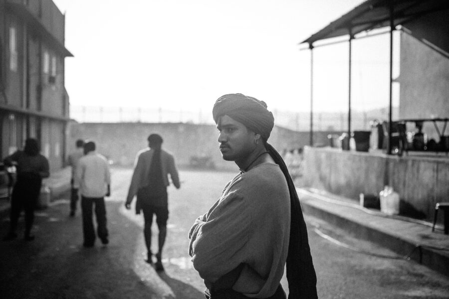 A junior artiste waits outside the sets of a movie in Ramoji Film City, Hyderabad. October 2014.