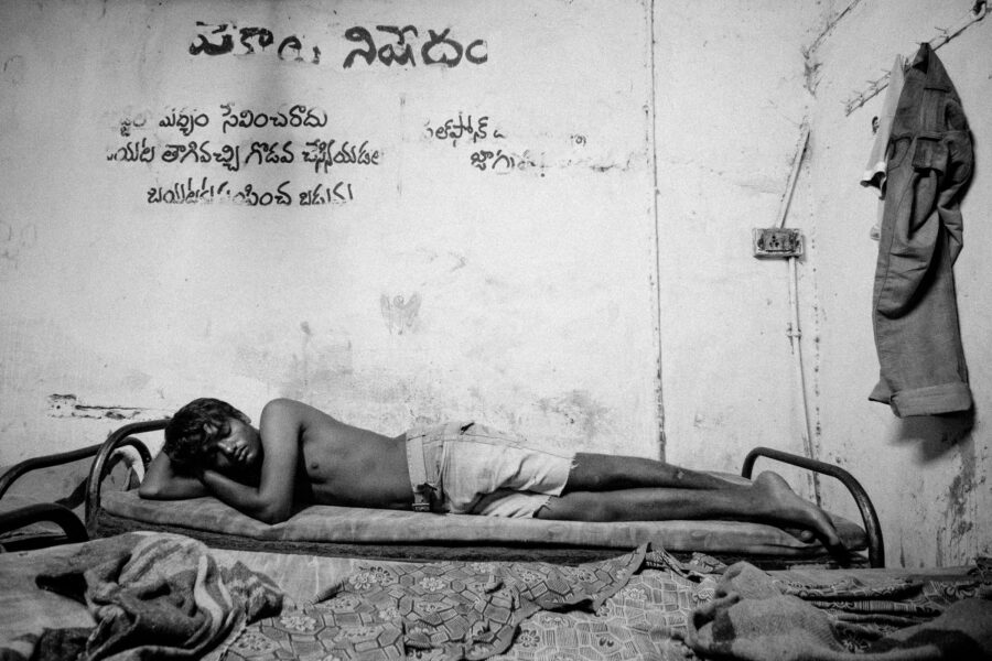 Ashok, a young artiste and film set construction crew worker, rents a bed at a lodge in Krishna Nagar for INR 30 (USD 0.50) a night. July 2012.