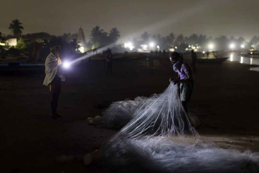 16 November 2022, Pudimadaka, Andhra Pradesh, India- Fishermen sort their nets before heading out into the Bay of Bengal on their small motor-powered sailboats.  This photo mission has been supported by Central Institute of Fisheries Technology (ICAR- CIFT), India.