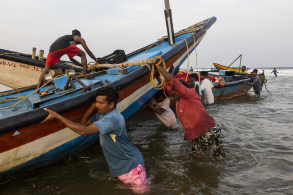 18 November 2022, Mangamaripeta, Andhra Pradesh, India- Fishermen pull boats anchored in the sea into a creek as a cyclone warning was issued in the Bay of Bengal and the sea turned rough.  This photo mission has been supported by Central Institute of Fisheries Technology (ICAR- CIFT), India.