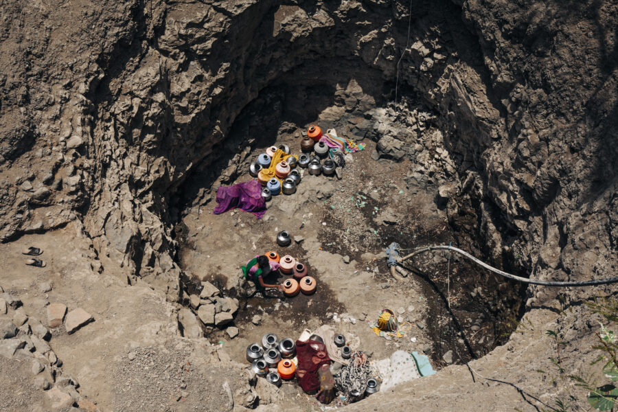 A woman uses a tumbler to fill her pot from a small puddle on the bed of a well in Atola in Latur, Maharashtra. The previous day, Kevalbai Kamble, 45, stood in a line at the village's community tap for two hours and collapsed before she could collect her two pots of water. She was declared 'brought dead' at the Government Hospital in Latur. Her 80-year-old mother who is half-blind has to live alone now and nobody knows how she will get her water. May 04, 2016.