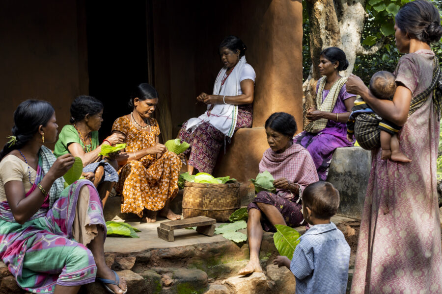 Sora shaman Lokami and women from the family of Sakana Soboro stitch leaf cups, to be used during a trance ritual in Jorrepi, Odisha, India.