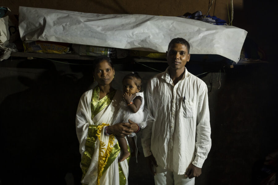 Adam Raika, 36, and Sanju Bhuyan, 30, with their daughter Bivanshi on her first birthday in Sogad, Odisha, India.