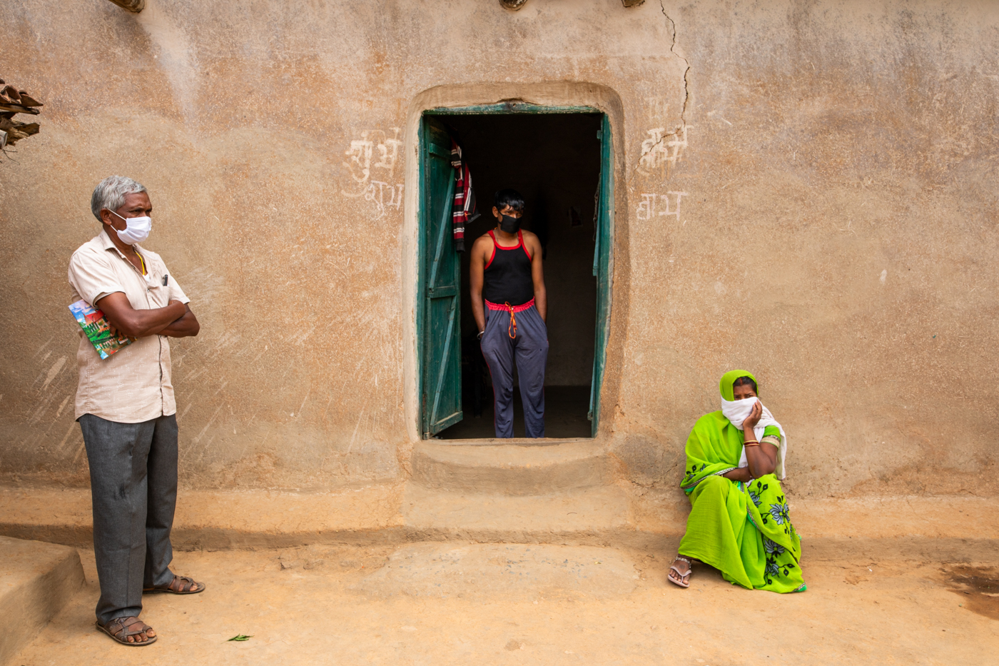 Kausalya Yadav, 30, who tested positive for COVID-19 despite being fully vaccinated, with her husband Rajkumar Yadav, 35, and a member of a contact tracing team at home in Poksari in Surguja, Chhattisgarh, India. May 25, 2021.