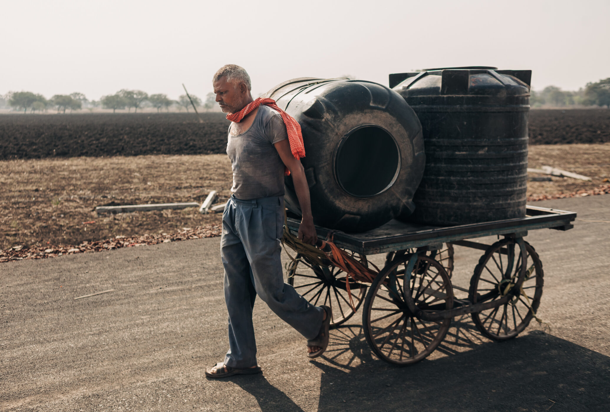 A man pulls a cart holding two water tanks to a nearby public tap in Dharur in Beed, Maharashtra. March 23, 2016.