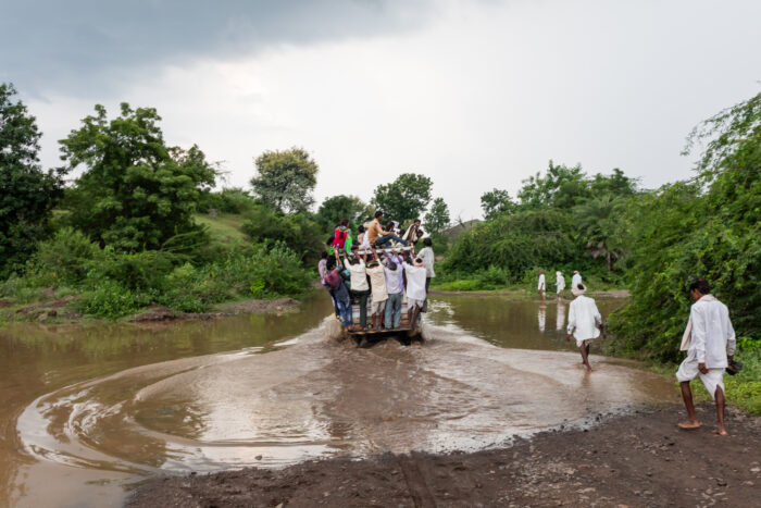 A jeep carrying Adivasis (Indigenous people) up the hill towards Chandankhedi in Dhar, Madhya Pradesh, passes through the rushing backwaters of the Sardar Sarovar Dam's reservoir. On June 17, all gates of the controversial dam on the river Narmada were closed together for the first time, leading to the gradual submergence of areas upstream. September 11, 2017.